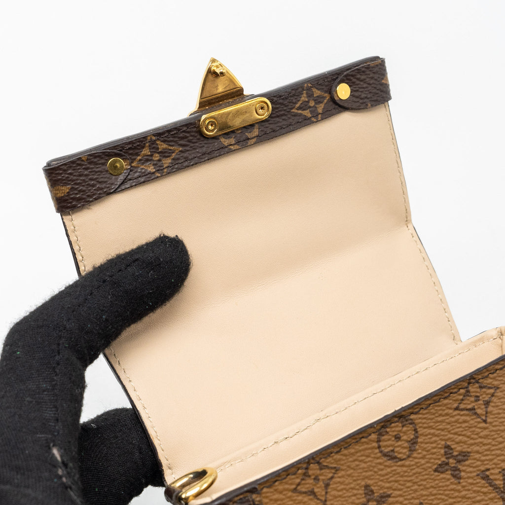 VERTICAL TRUNK POCHETTE WITH CHAIN MONOGRAM REVERSE CANVAS GHW