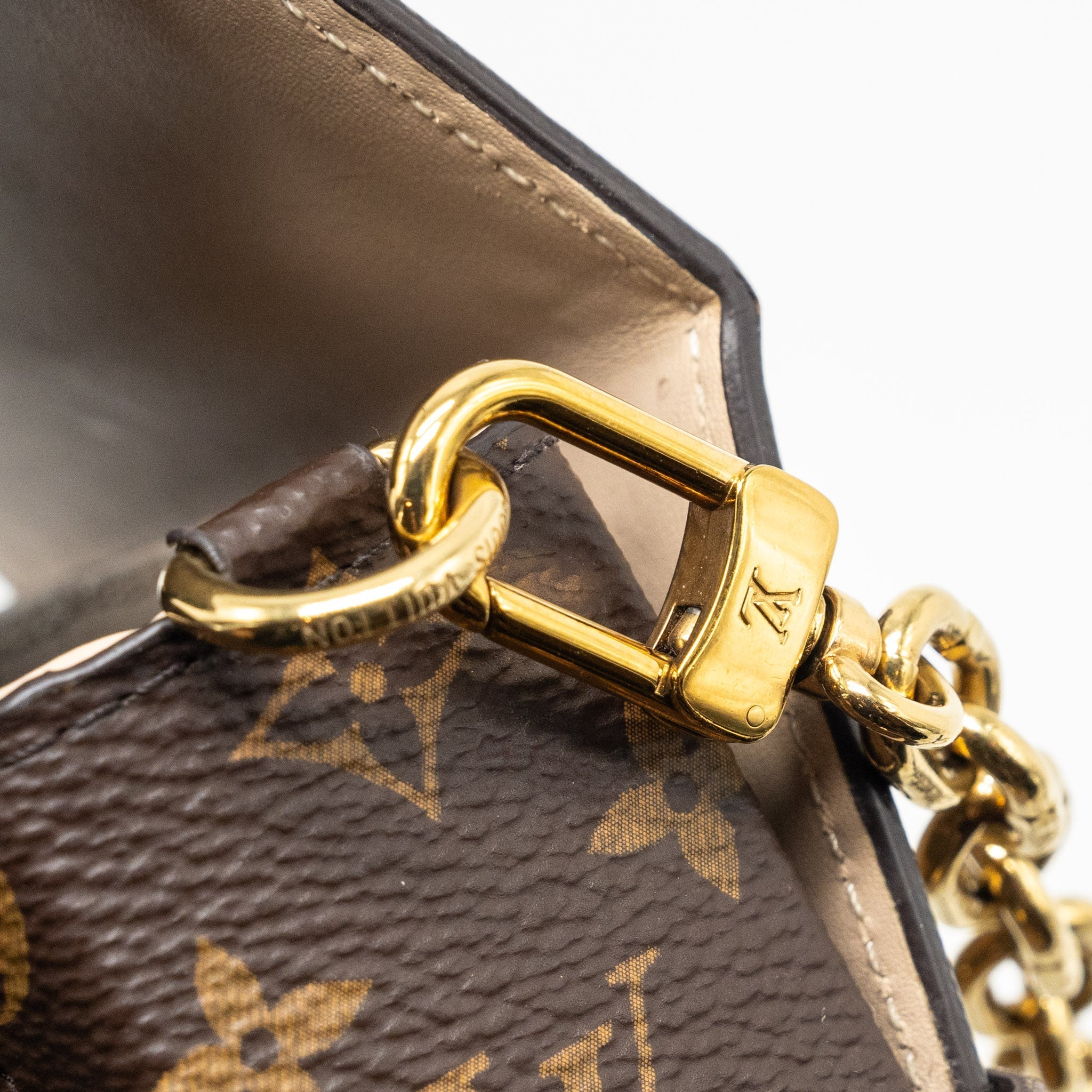 VERTICAL TRUNK POCHETTE WITH CHAIN MONOGRAM REVERSE CANVAS GHW