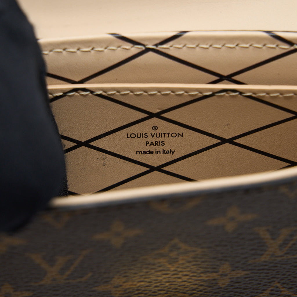 VERTICAL TRUNK POCHETTE MONOGRAM CANVAS GHW