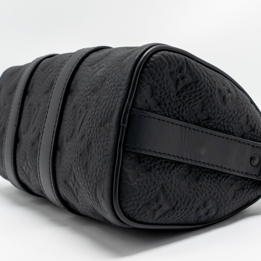 KEEPALL BANDOULIERE 25 MONOGRAM TAURILLON LEATHER BLACK WITH BLACK HARDWARE